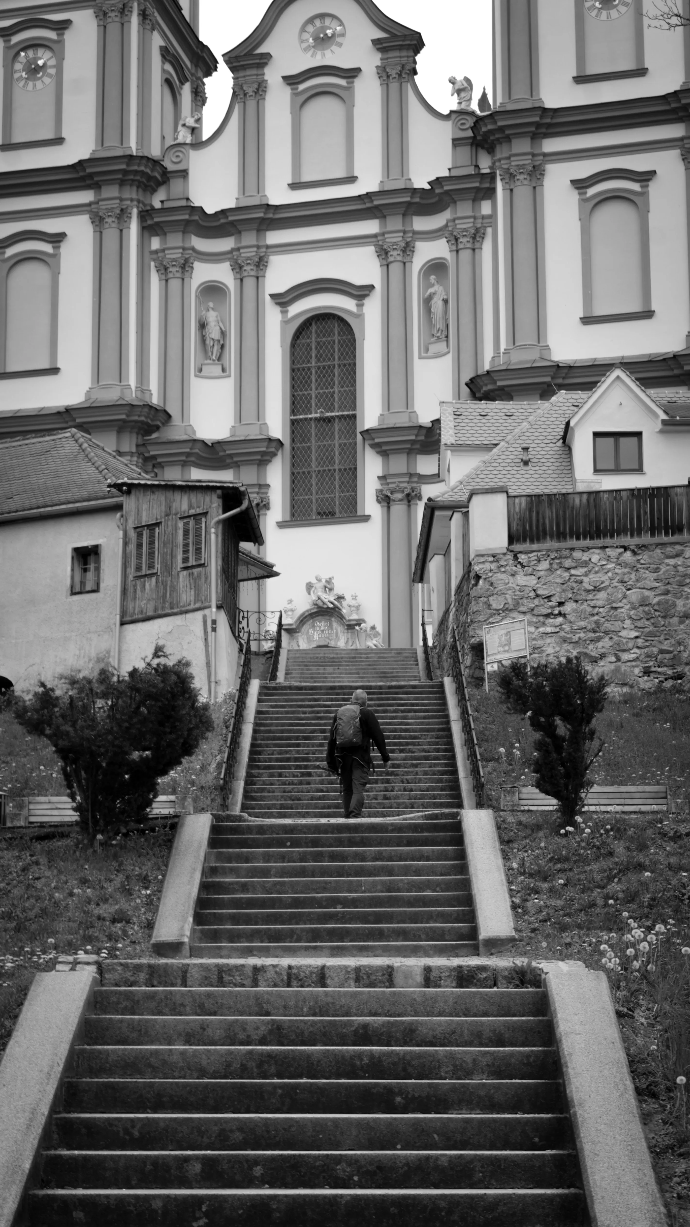 Man walking up the steps to a basilica